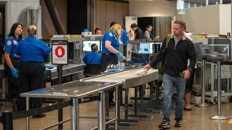 A person passes through TSA security screening at an airport