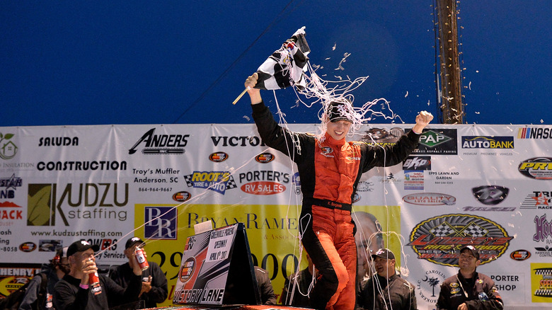 Kyle Benjamin on top of a car celebrating after NASCAR win in 2017