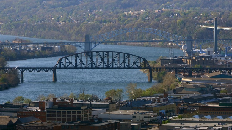 Iron bridges spanning the river in an industrial area of Pittsburgh