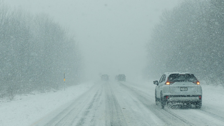 A car driving through a blizzard in Syracuse, New York