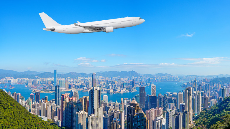 Plane takes off over Hong Kong skyline