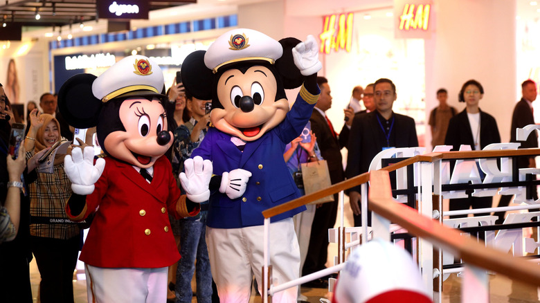 Captain Mickey and Minnie Mouse aboard a cruise ship