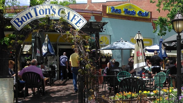 Bon Ton Cafe's leafy patio with the cafe's signage over the archway
