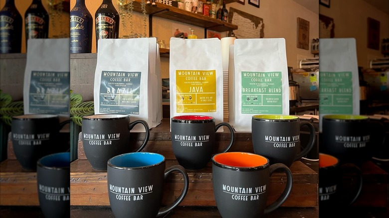 Inside store with branded coffee mugs and bagged coffee beans
