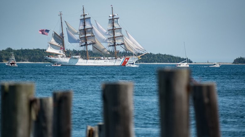 The USCGC Eagle sails along the coast
