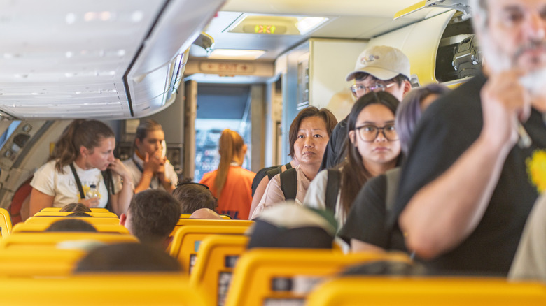 People boarding a crowded flight