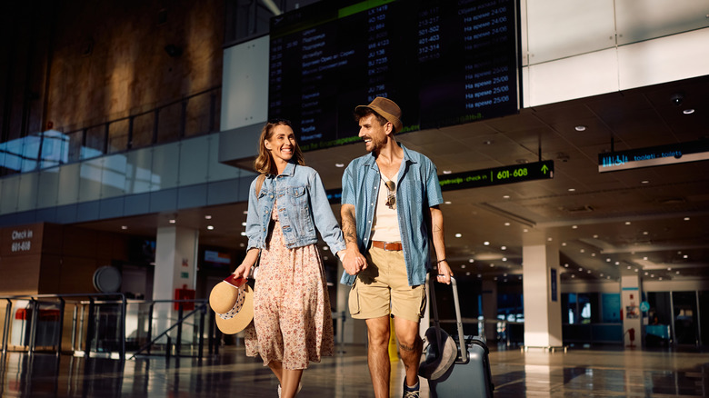 Couple walking through an airport