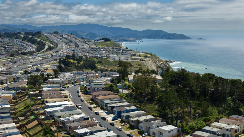An arial view of tightly packed houses overlooking the ocean in Daly City, California.