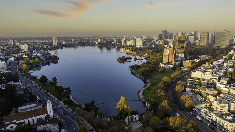 An aerial view of Lake Merritt and the skyscrapers and trees surrounding the water in Oakland, California.
