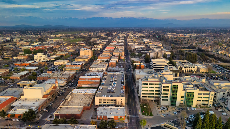 Aerial of Downtown Visalia with the Sierra Nevada mountains in the background.