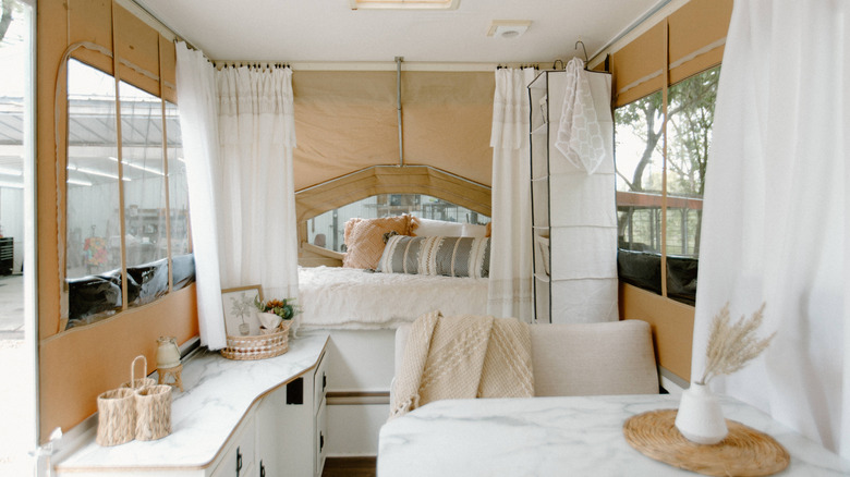 Interior of pop-up camper decorated in white and tan