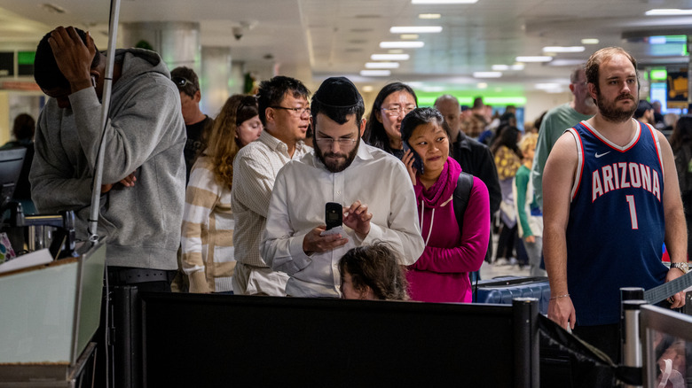 Passengers in line waiting for lost luggage help, Houston