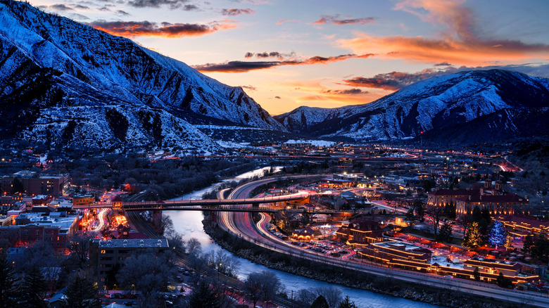 Panoramic shot of Glenwood Springs, Colorado with a winding river and the snow-capped Rockies