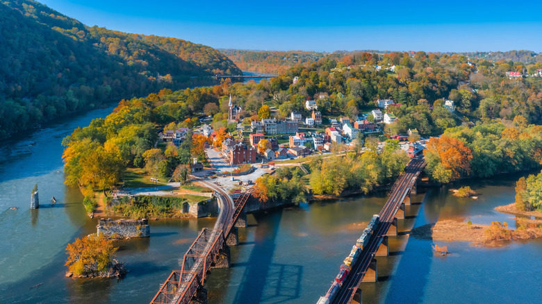 Aerial view of Harpers Ferry, West Virginia with town center, railroad bridges, and surrounding mountains