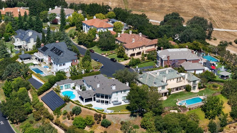 Aerial view of large houses with backyard pools