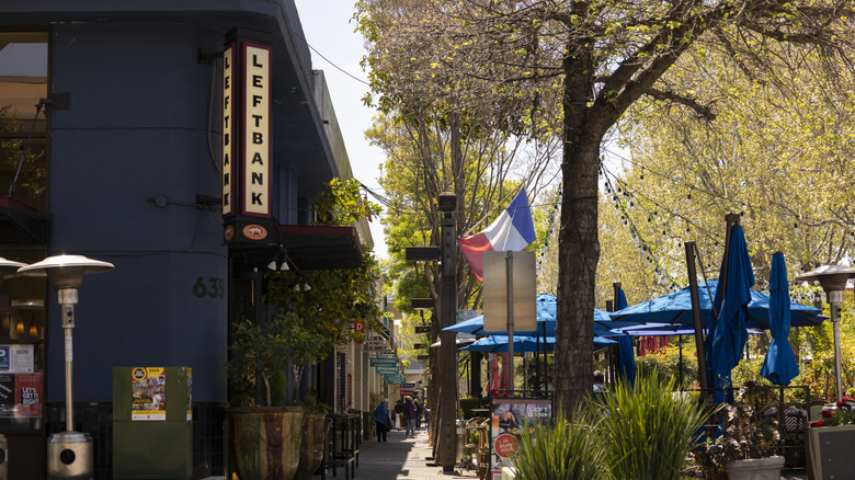 People walk past restaurants and patios in downtown Menlo Park
