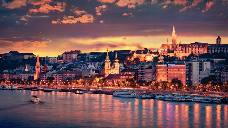 Budapest skyline lit up over the Danube at sunset
