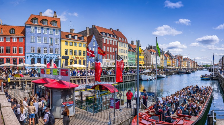 Crowds of people around the harbor and in boats, Nyhavn, Copenhagen