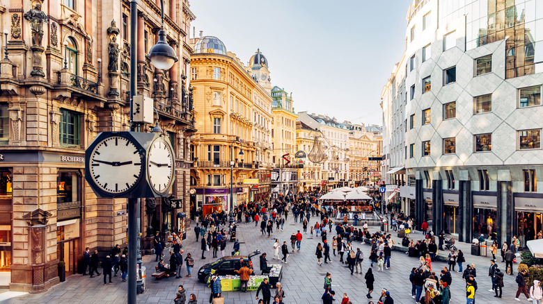A busy pedestrian mall lined with historic and modern buildings  in winter