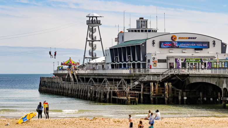 Bournemouth Pier juts out of the sandy beach, with a zip line and RockReef indoor climbing area