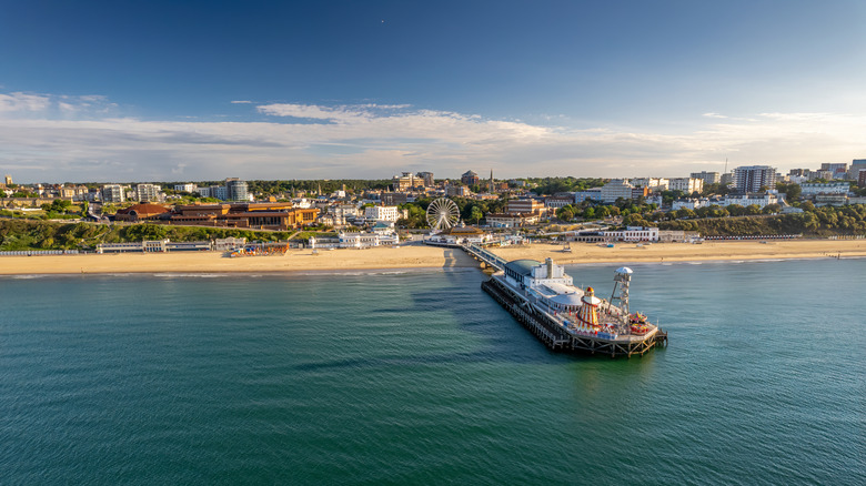 A sunny day at Bournemouth Pier, with a Ferris wheel and promenade in the background