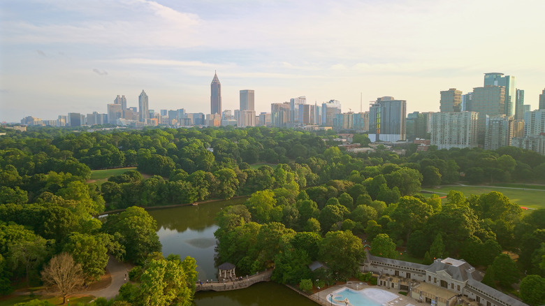skyline view of the city of Atlanta with trees and a pond