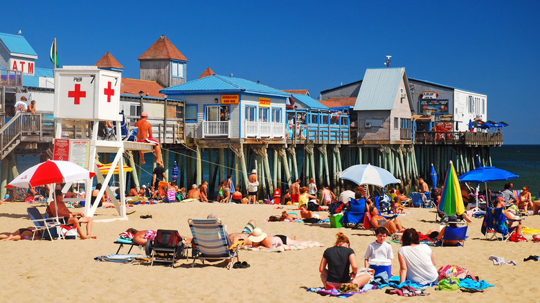 Crowds enjoying a beach day at Old Orchard Beach boardwalk pier in Maine