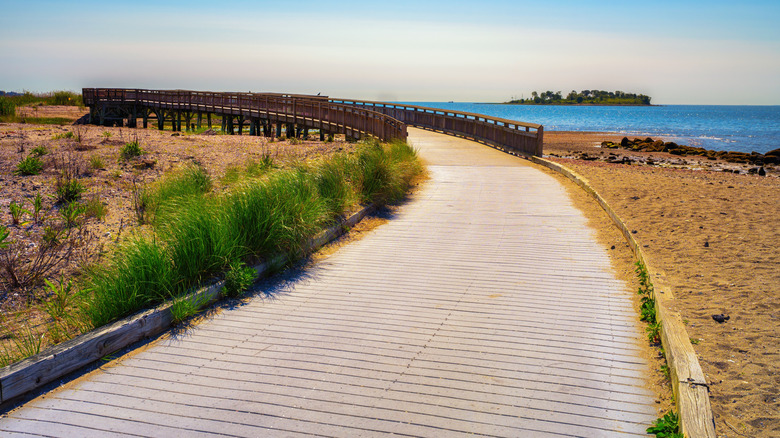 The wooden boardwalk at Silver Sands State Park in Milford, Connecticut, overlooking Charles Island in Long Island Sound
