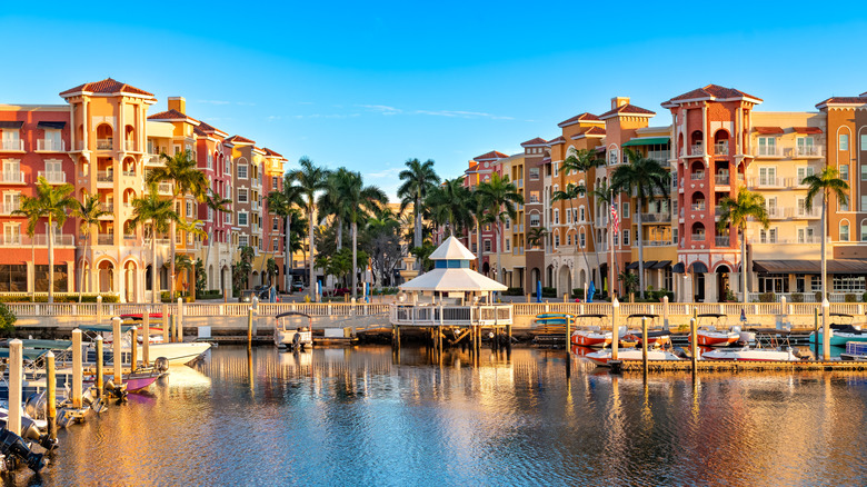 Morning light on Naples, Florida, with waterfront buildings and boats under a clear sky
