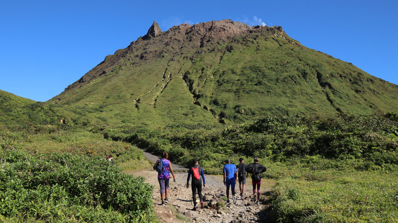 People hiking the summit trail to La Soufriere volcano