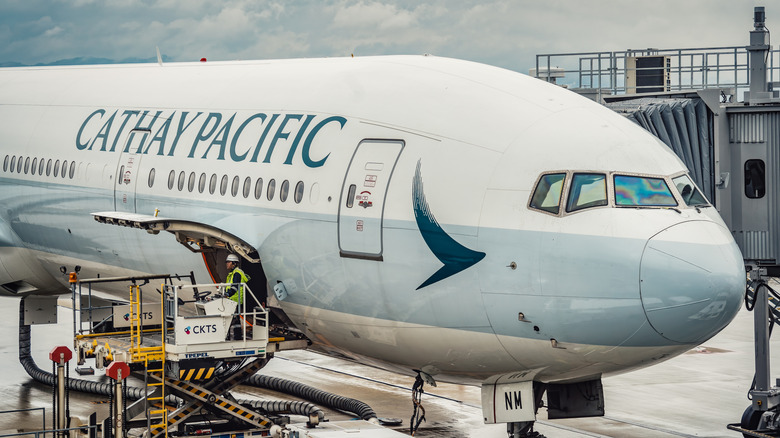 A Cathay Pacific Airlines plane parked at a gate