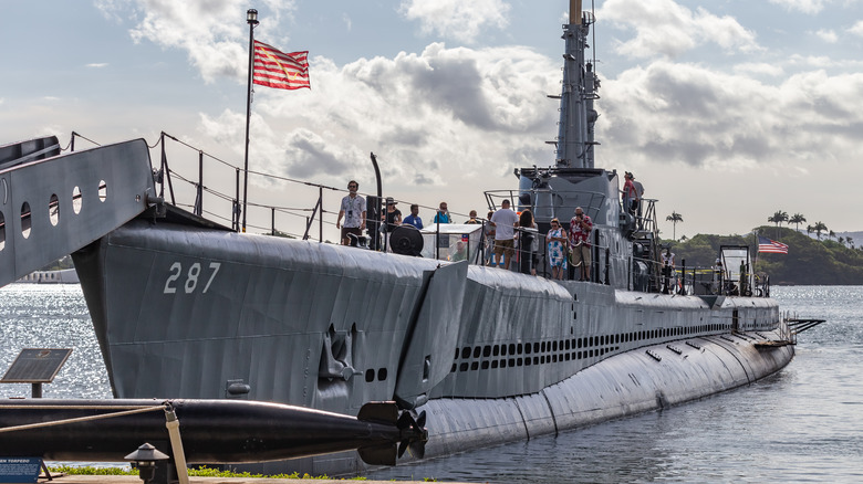 Tourists explore the USS Bowfin submarine.
