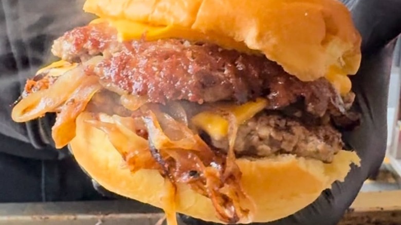 closeup of burger with onions from Tripp Burgers