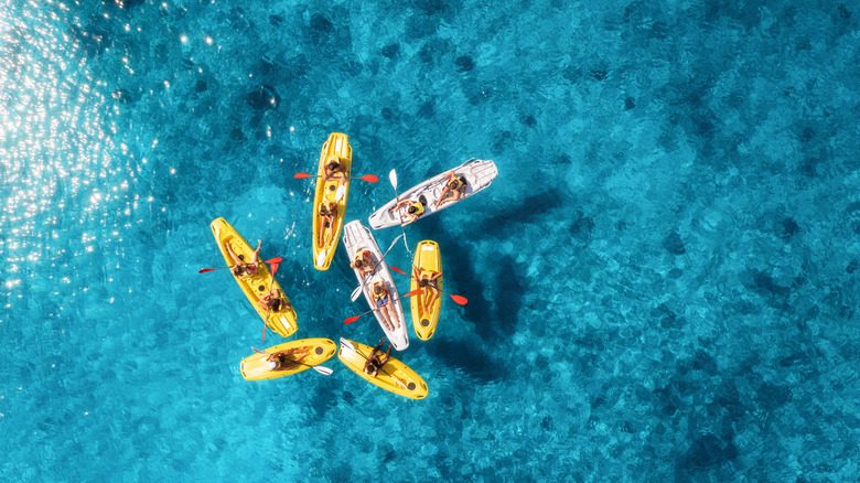 Aerial view of a group of kayakers in blue water