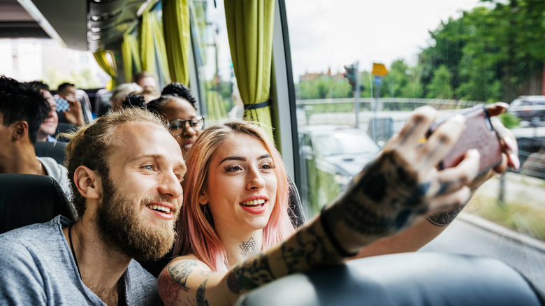 Young couple takes a selfie on a bus tour