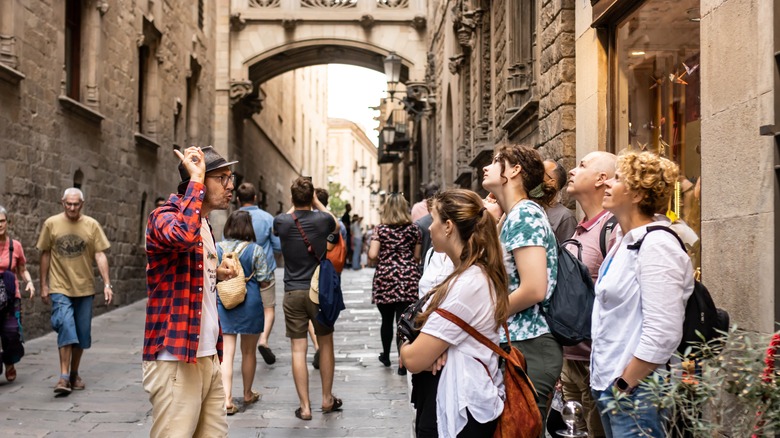 Tour guide leads a group in the streets of Barcelona