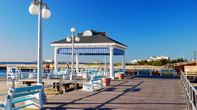 A look down the boardwalk with many people in Avon by the Sea along the New Jersey coast.