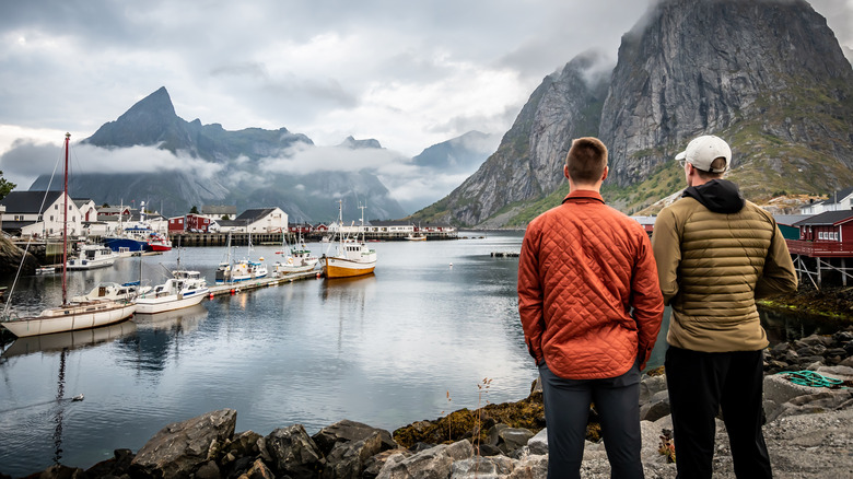 Two men looking at boats