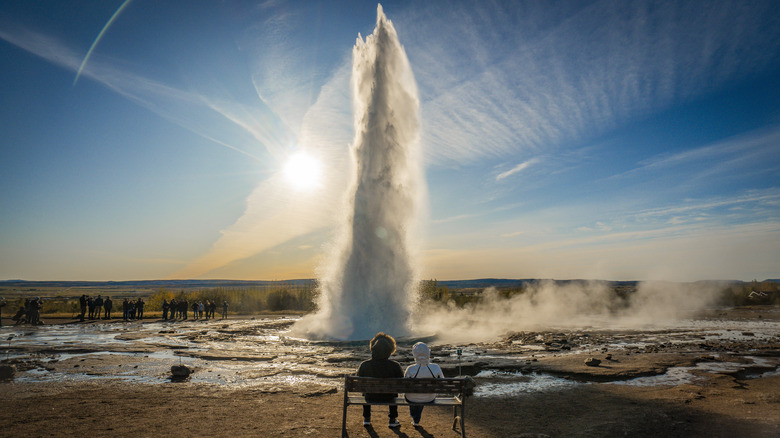 Retirees watch the Strokkur geyser in Iceland
