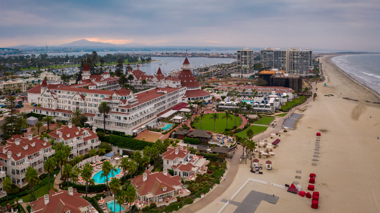 Aerial view of Coronado Beach with the red top of the iconic Hotel Del Coronado on view