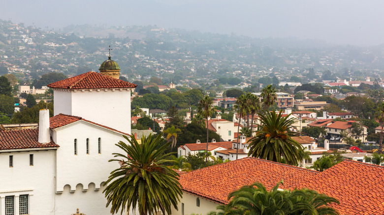 Spanish-style architecture in California's hills dotted with palm trees