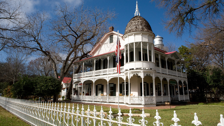 A white, Victorian-era mansion in Gruene, Texas