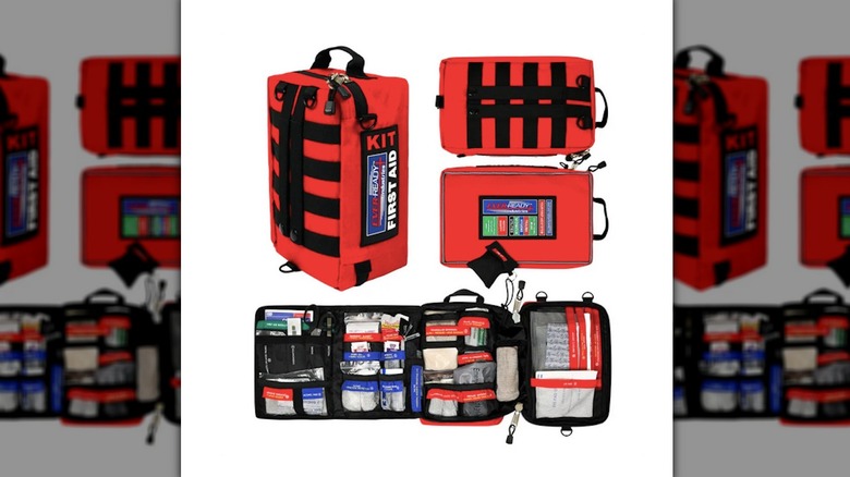 Red first-aid kit bag with items organized inside