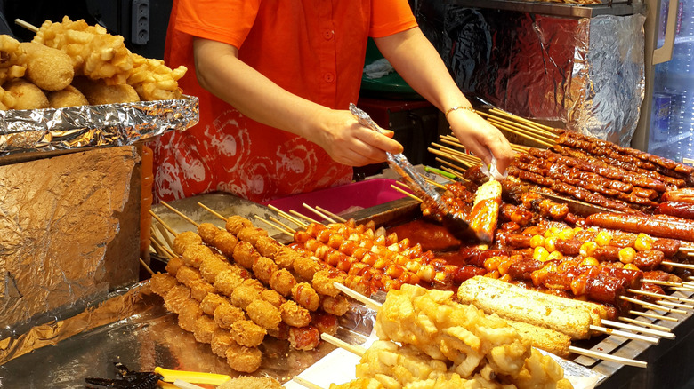 Vendor serving brightly colored Korean street food in Myeongdong, South Korea