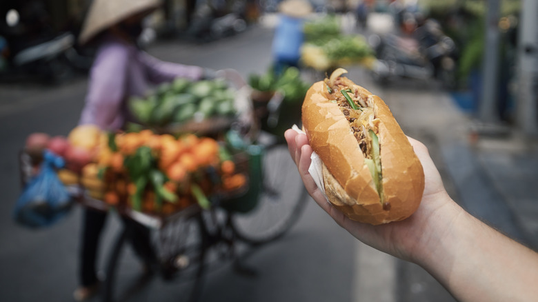 Close-up of traditional Vietnamese baguette filled with pate, meat and vegetables.