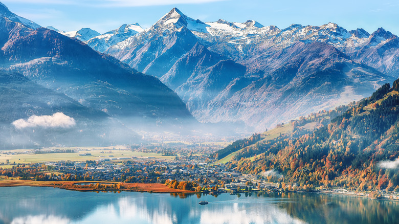 A snow-capped mountain rises above Zell am See lake in Austria