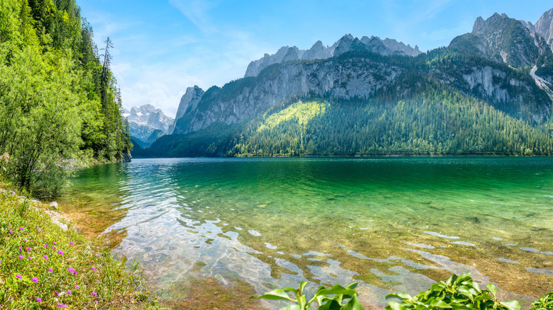 Jagged mountains rise over a stunning lake in Austria