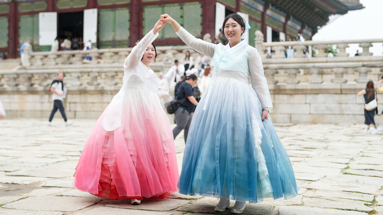 Two Korean women dance at Gyeongbokgung Palace in Seoul