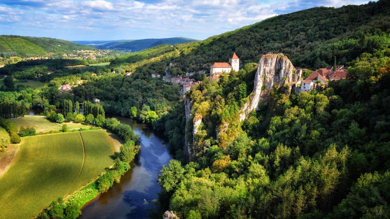 Dramatic riverside village along a river in France's Lot region