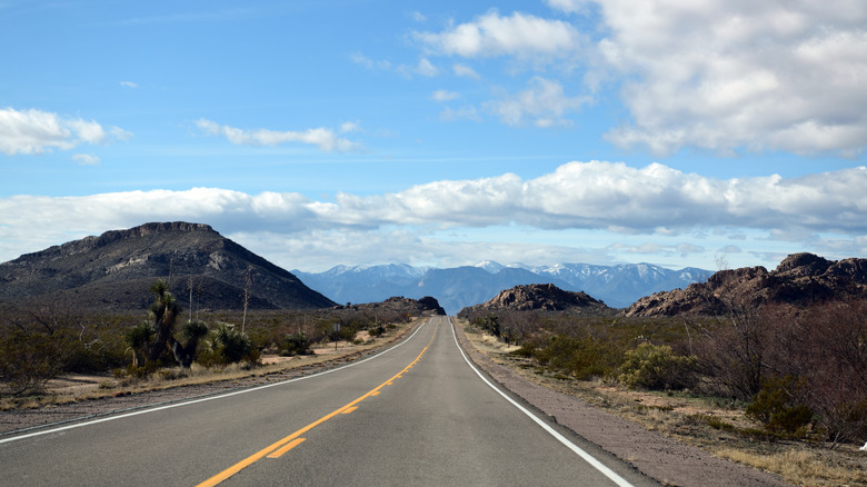 a highway with snow covered mountains